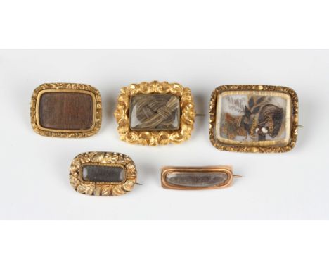 A gilt metal rectangular brooch, circa 1830, glazed with a hairwork locket compartment, length 2.6cm, and four further early 