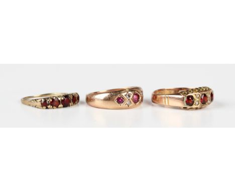 A 9ct gold, ruby and diamond ring, mounted with three circular cut rubies alternating with two pairs of circular cut diamonds