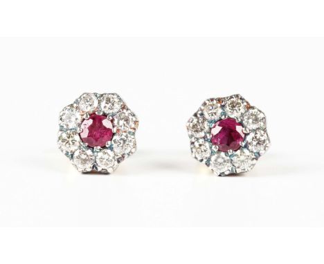A pair of gold, silver, ruby and diamond cluster earstuds, each mounted with a circular cut ruby within a surround of eight c