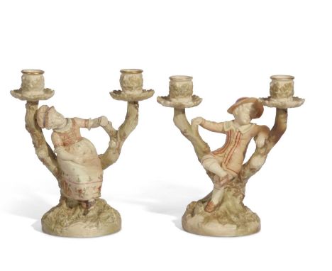 Pair of Worcester Hadley candlestick figures modelled as children leaning against branches with candle sconces above, 22cm ta