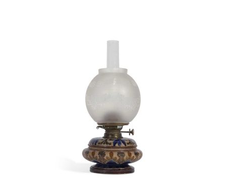 A Doulton Lambeth oil lamp c1882 of compressed form the stoneware body decorated with an incised floral design in green and b