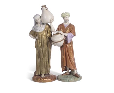 Two large 19th century Hadley Worcester figures of water carriers decorated in shot enamels the base impressed Hadley dated 1