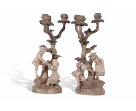Two large candlestick figures by Worcester both modelled with children by tree stump with three sconce candelabra above (2) 4