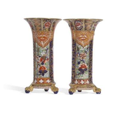 A pair of early 20th century Copeland Spode cylindrical vase of lobed form with an Imari design raised on three claw and ball