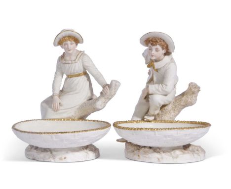 Pair of Royal Worcester figural comports decorated with a boy and a girl in Hadley style mounted on tree stumps 20cm tall (2)