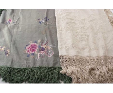 A fine 19th century cream silk tablecloth, probably Chinese, finely embroidered with floral sprays within handstitched tassel