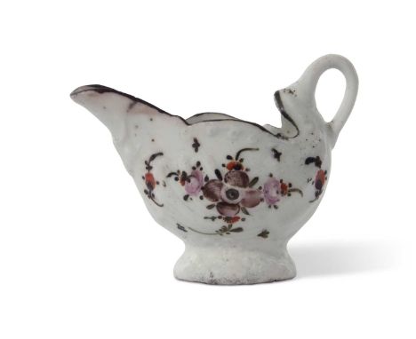 A Lowestoft porcelain dolphin ewer decorated with an early polychrome design of flowers beneath a black rim.5cm high