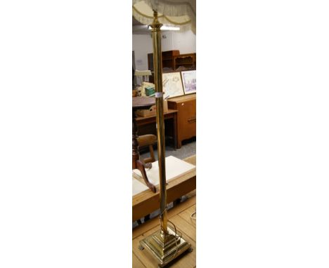 A traditional brass standard lamp with shade
