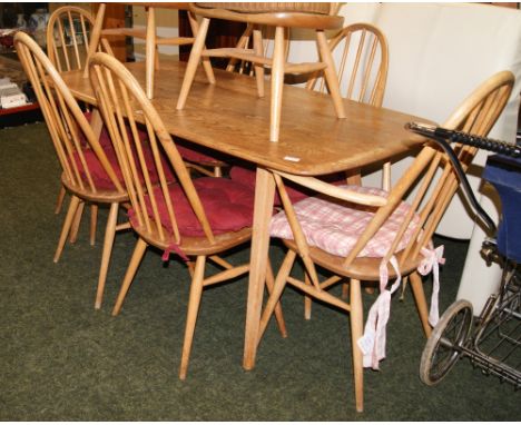 A mid 20th Century Ercol-style elm rectangular dining table, with a set of six (4+2) hoop-back chairs