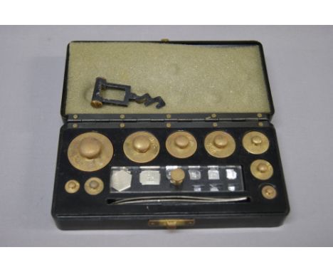 A cased set of precision scales and weights