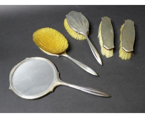 An Art Deco silver backed dressing table set, decorated in an engine turned sunburst guilloche design, comprising a pair of h