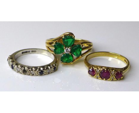 Three 9ct gold rings, comprising an early 20th century three stone ruby ring, size M, a white gold, diamond and blue sapphire