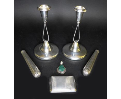A pair of modernist designed candlesticks with weighted bases, 8 by 15.3cm high, Adie and Co, Birmingham 1958, together with 
