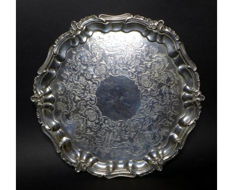 A Victorian silver salver tray, of circular Rococo form with Chippendale pie crust and C scroll rim, engraved foliate decorat