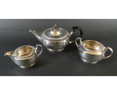 A George V three piece silver tea set, comprising of squat form teapot with ebonised handle and finial, 22.5 by 12.3 by 10cm 