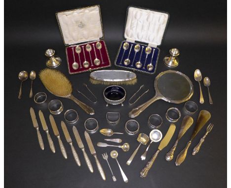 A group of Victorian and later silver wares, two cased sets of six teaspoons, including nine napkins rings, two silver caddy 