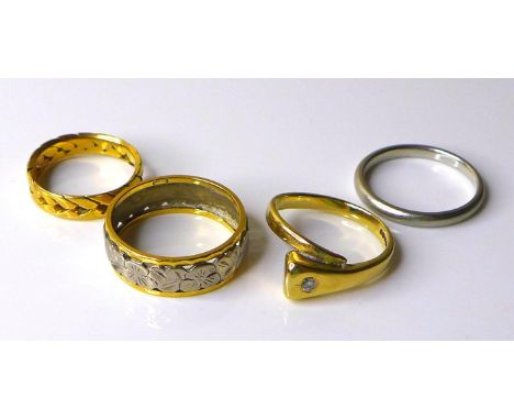 A group of four rings, comprising a platinum wedding band, size N, 3.8g, an 18ct white and yellow gold ring with continuous e