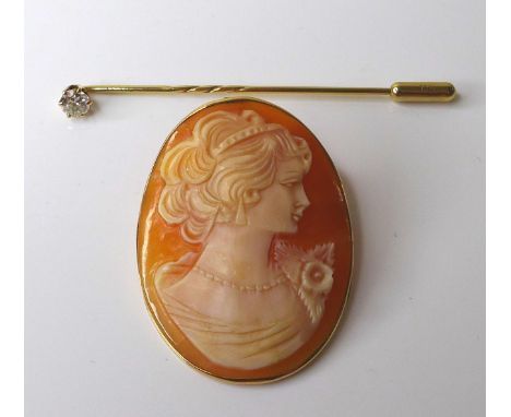 A 9ct gold stick pin, inset with a 0.2ct solitaire diamond, 6.2cm long, 1.4g, together with a 9ct gold mounted cameo brooch, 