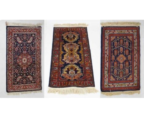 Three small wool rugs, all with Persian-style decoration, to include one with label verso 'USSR C+R', 94cm x 153cm and smalle