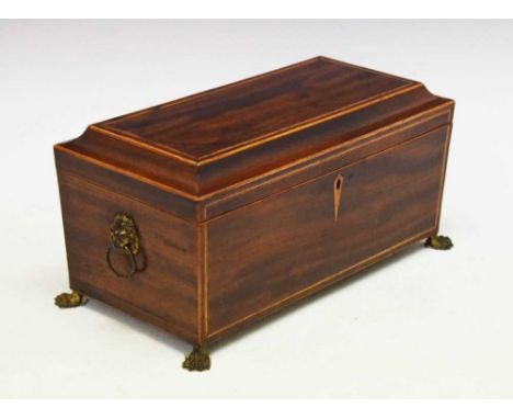 Regency inlaid mahogany sarcophagus tea caddy, enclosing twin canisters, the body with ebony and boxwood line inlay and lion 