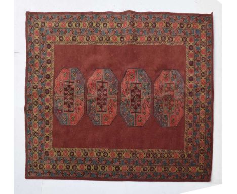 Wool rug or carpet, flecked burgundy field with four large guls, within multi border and bound selvedges, 240cm x 305cm