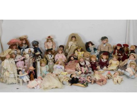 Quantity of approximately thirty bisque headed dolls all varying in size to include; 'The Ashton-Drake Galleries', 'Knightsbr