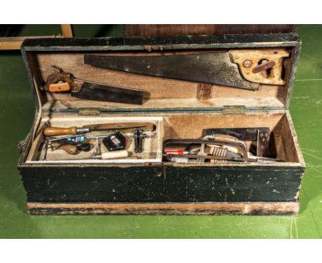 A wooden tool box with a quantity of tools