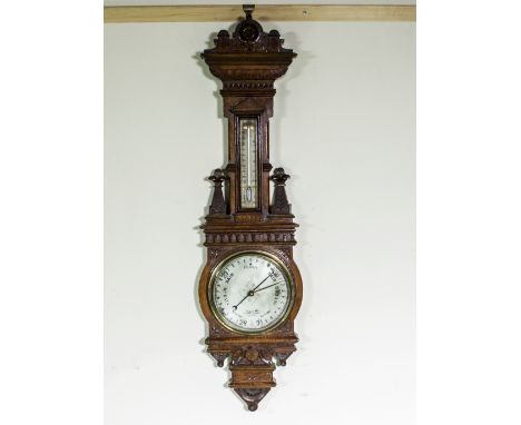An impressive Victorian carved oak barometer.