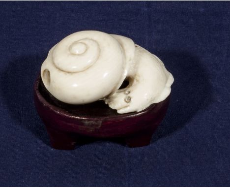 A Japanese signed netsuke snail on a hardwood base