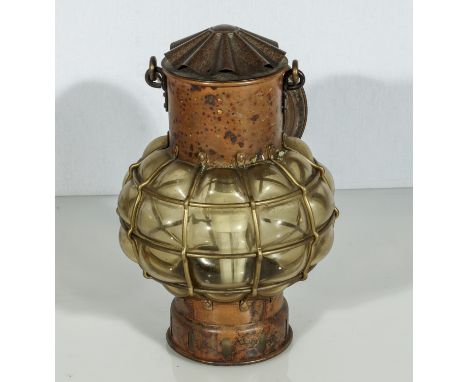 A copper and glass ships lamp