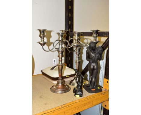 A PAIR OF SILVER PLATED THREE LIGHT CANDELABRA, polished through to the copper in places, approximate height 40.5cm, together