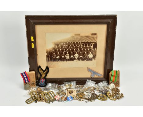 A BOX CONTAINING A LARGE NUMBER OF WWI/WWII era Military buttons, collar dogs, cap badges, enamel pin badges etc, also boxed 