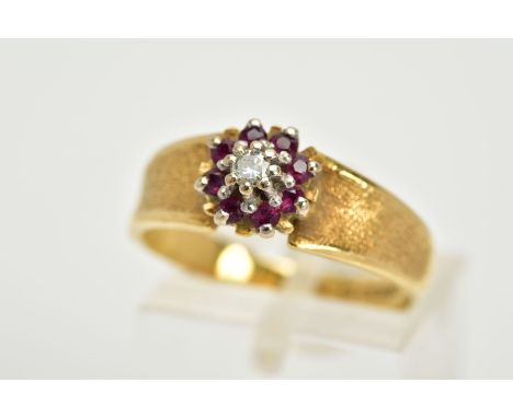 AN 18CT GOLD RUBY AND DIAMOND CLUSTER RING, designed with a central illusion set single cut diamond, within a circular cut ru