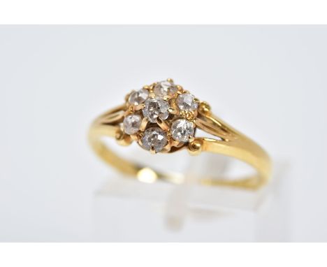 AN EARLY VICTORIAN 18CT GOLD DIAMOND CLUSTER RING, slightly raised cluster set with seven claw set, old cut diamond to the tr