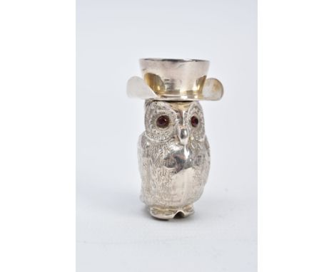 A WHITE METAL OWL VESTA, decorative engraved owl with opening hat lid, set with circular cut garnet eyes, striker to the base