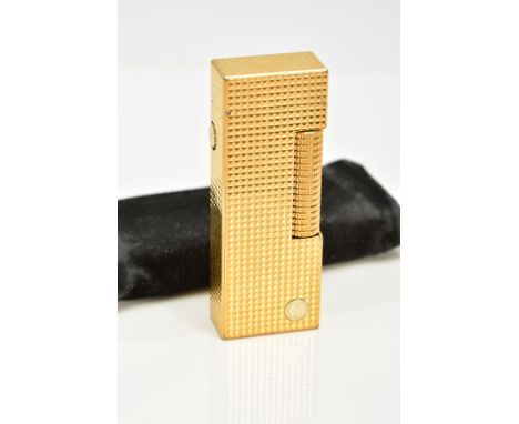 A GOLD PLATED DUNHILL LIGHTER, of an engine turn design, stamped the base 'Dunhill', approximate dimensions 64.2mm x 23.9mm x