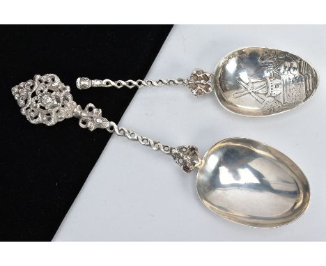 TWO ORNATE SILVER SPOONS, the first with a mask and foliate scroll detailed handle, with a possible repair or replacement to 