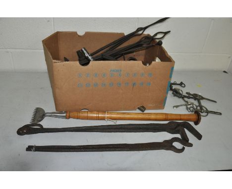 A TRAY OF BLACKSMITHS AND FARRIERS TOOLS including bits, grooming tools, etc