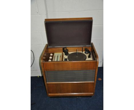 A FERGUSON 322RG VINTAGE RADIOGRAM in walnut case with a Garrard RC75M turntable (PAT pass and working but radio needs attent