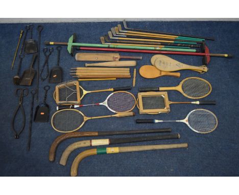 A COLLECTION OF VINTAGE SPORTS EQUIPMENT, to include seven hickory golf clubs, six badminton rackets, three hockey sticks, tw
