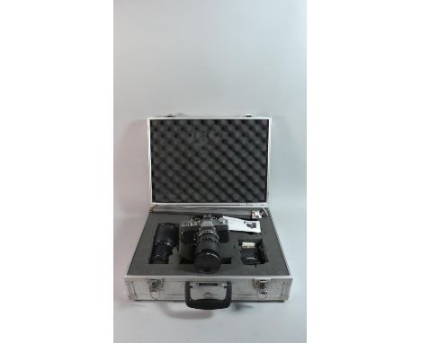 A Cased Camera Set to Include Minolta SRT 303, Minolta Telescopic Lens, Tripod, Flash Gun, Accessories 