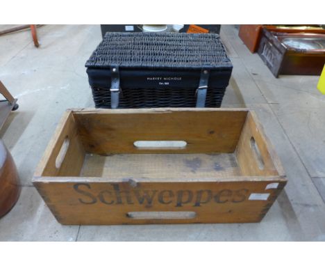 A vintage pine Schweppes advertising crate and a painted Harvey Nicholls wicker basket 