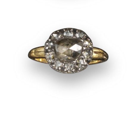 A diamond cluster ring, set with a central rose-cut diamond within a rose-cut diamond border, in closed-back silver and gold 