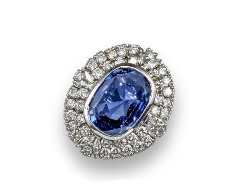 A large sapphire and diamond cluster ring, the oval-shaped sapphire weighs approximately 12.00cts and is set within concentri