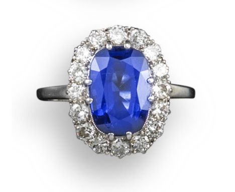 A sapphire and diamond cluster ring, the cushion shaped sapphire weighs approximately 4.00cts, set within a surround of old c