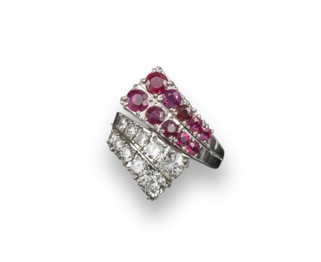 A French ruby and diamond crossover ring, each section set with two lines of graduated circular-cut diamonds or circular-cut 