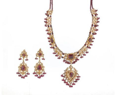 An Indian gem-set necklace, mounted with three cushion-shaped garnets and diamonds in gold mounts, joined with garnet beads a