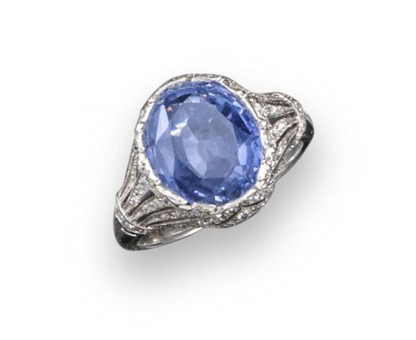 A sapphire and diamond ring, the oval-shaped sapphire weighs approximately 6.80cts and is set within carved and pierced diamo