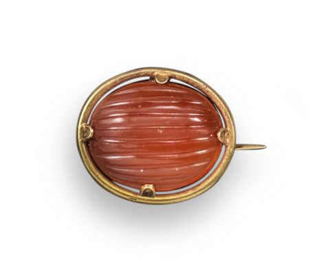 A gold mounted carnelian brooch by Castellani, the oval carnelian with lobed decoration and set in a plain gold mount, 2cm wi