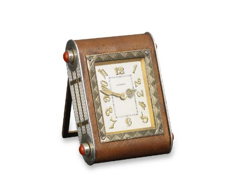 An Art Deco gold, coral and silver 'Kodak' table clock by Cartier, designed as a fluted 'Kodak' camera with brown leather bor